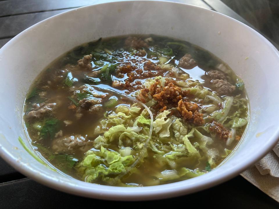 A bowl of gaeng jeud woon sen - broth and noodles with pork meatballs, cabbage, pepper and fresh herbs - at Wilaiwans in Montpelier on Nov. 3, 2023.