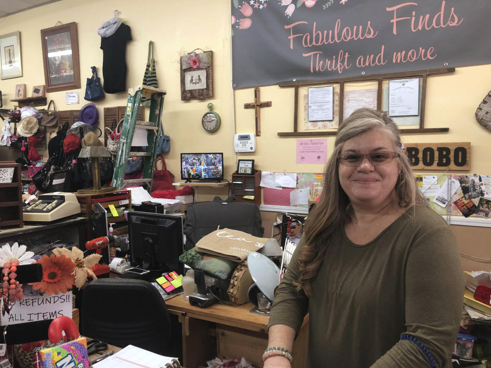 In this Jan. 24, 2020 photo, Tammie Bobo sits in her thrift shop in downtown Adel, Ga.Bobo is concerned that the new Southwell hospital does not have an emergency room. "You never know what the next minute brings," she said. The new hospital replaced an old hospital with an emergency room that drained resources. (AP Photo/Sudhin S. Thanawala)