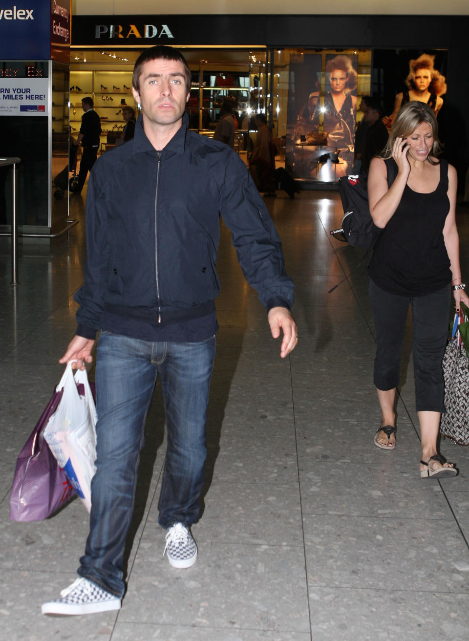 Liam Gallagher with his wife Nicole Appleton walk through Heathrow Airport in Middlesex. PRESS ASSOCIATION Photo. Picture date: Friday August 7, 2009. Photo credit should read: Steve Parsons/PA Wire