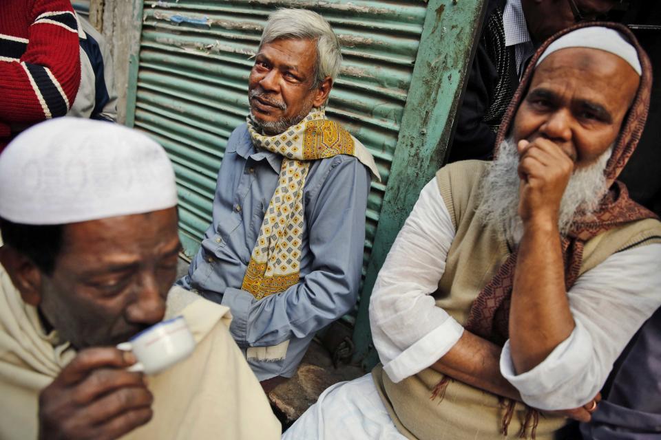 Bangladeshi people sit near a polling station after casting their votes in Dhaka, Bangladesh, Sunday, Jan. 5, 2014. Police in Bangladesh fired at protesters and more than 100 polling stations were torched in Sunday’s general elections marred by violence and a boycott by the opposition, which dismissed the polls as a farce. (AP Photo/Rajesh Kumar Singh)