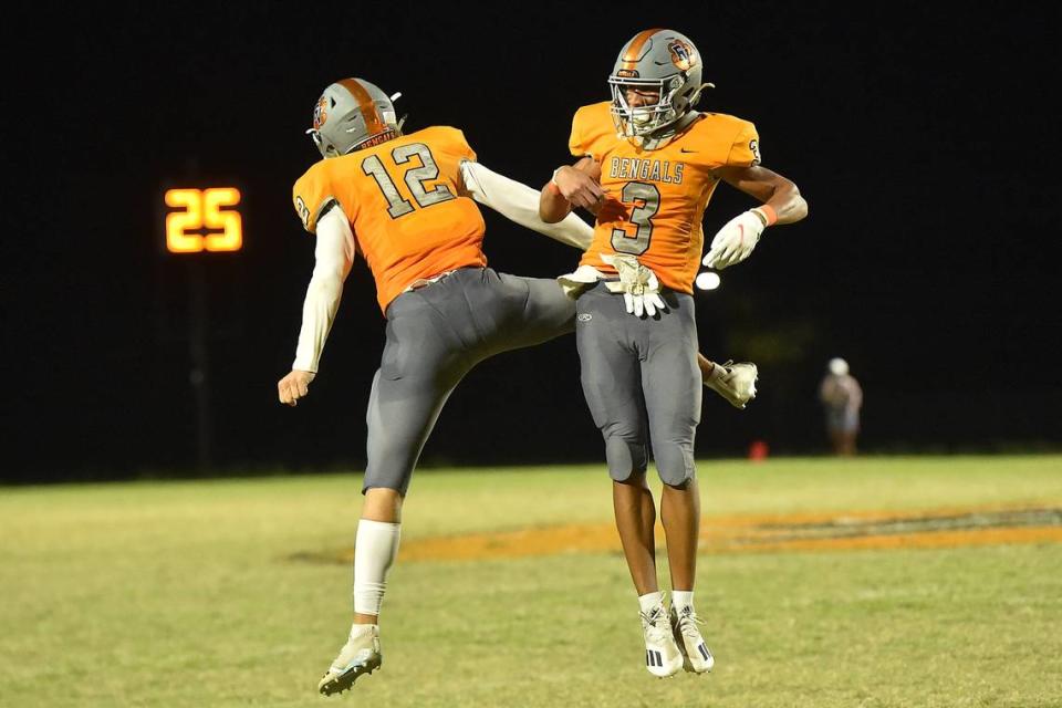 Fuquay-Varina’s Malcolm Ziglar (3) celebrates with Dylan Smith (12) after the game winning touchdown late in the fourth quarter. The Fuquay-Varina Bengals and the Holly Springs Golden Hawks met in a non-conference football game in Fuquay-Varina, NC on September 3, 2021. Steven Worthy