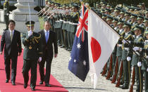 Australian Prime Minister Tony Abbott, center, reviews an honor guard during a welcome ceremony with Japanese Prime Minister Shinzo Abe, left, at Akasaka State Guest House in Tokyo Monday, April 7, 2014. Abbott is on a four-day official visit. (AP Photo/Koji Sasahara)