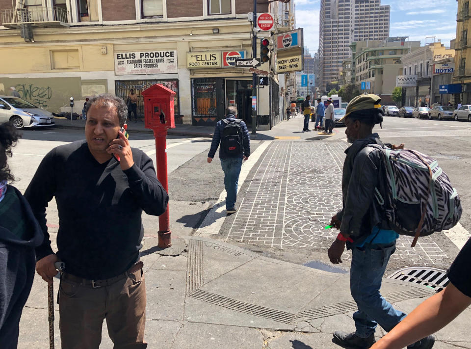 In this photo taken July 25, 2019, is market owner Ahmed Al Barak standing outside his store in the Tenderloin neighborhood of San Francisco. Al Barak says he doesn't see as much feces and urine on the streets after San Francisco posted a portable public toilet near his store in a neighborhood heavy with homeless people. San Francisco launched its "Pit Stop" program in July 2014 with three locations that now expanded to 25 and spread to Los Angeles, after children initially complained of having to side-step human waste on their way to school. (AP Photo/Janie Har)