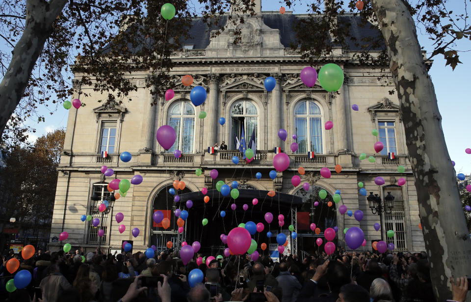 Balloons are released in front of the Paris 11th district town hall during a ceremony marking the third anniversary of the Paris attacks of November 2015 in which 130 people were killed, in Paris, Tuesday, Nov. 13, 2018. France's interior minister says French security services have foiled six terror attacks this year, as the country marks three years since gun and bomb attacks in Paris killed 130 people. (AP Photo/Christophe Ena)