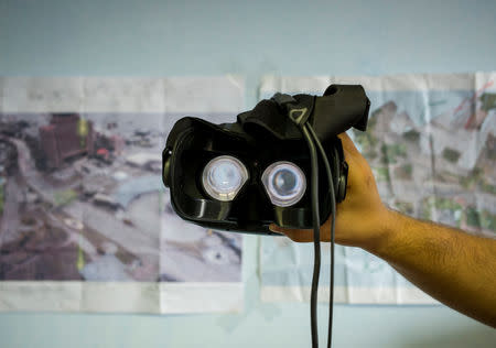 A co-founder of the New Cave Media Sergiy Polezhaka tests a simulator of virtual reality of the 2013/2014 demonstration in Ukraine, when dozens of protesters were killed in the final moments of Viktor Yanukovich's rule, in Kiev, Ukraine September 11, 2018. Picture taken September 11, 2018. REUTERS/Gleb Garanich