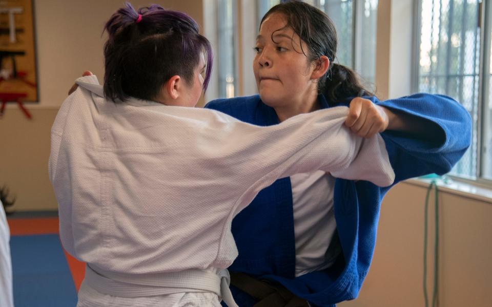 17-year-old Alejandra Ochoa, right, grapples with Alyx Long, 14, during a practice of the Stockton Judo Club at the McKinley Park Community Center in south Stockton.