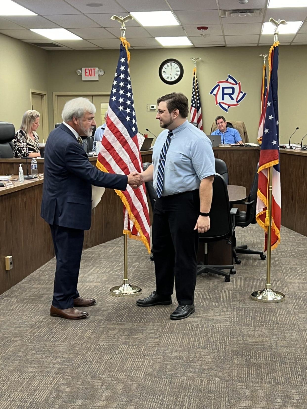 Ravenna Law Director Frank Cimino administers the oath of office to Tyler Marovich, who was recently elected to serve Ward 2.