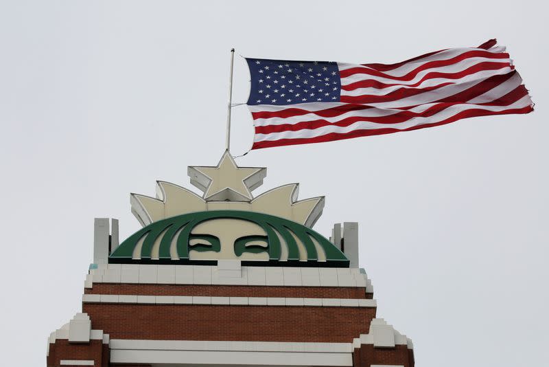 A flag flies above the company's headquarters as Starbucks Corp opens the first upscale Starbucks Reserve store at the Starbucks headquarters in Seattle