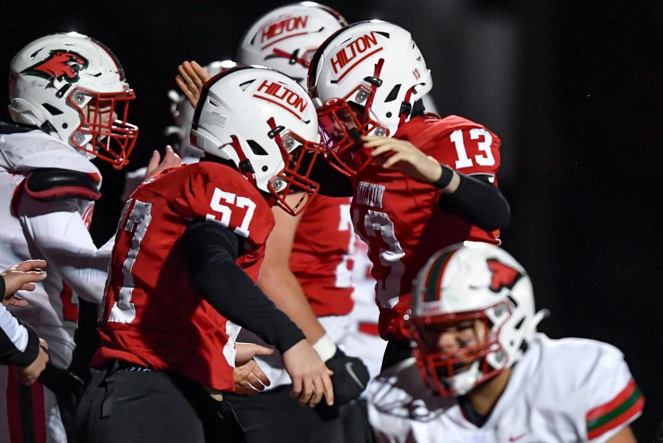 Hilton's Colton Thorp, right, celebrates with Giovanni Mattioli after scoring a touchdown against Jamestown during the NYSPHSAA Class A Far West Regional at Hilton High School, Monday, Nov. 21, 2022.