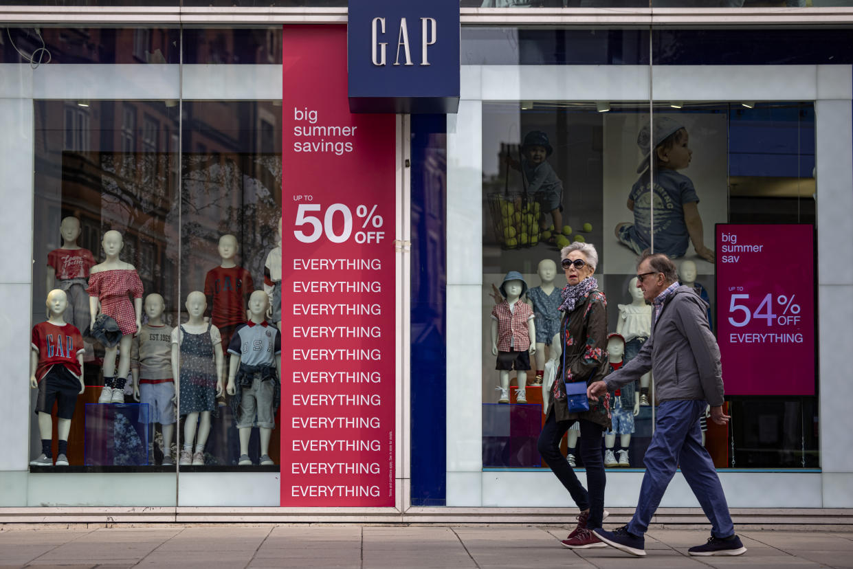 LONDON, ENGLAND - JULY 02: People walk past the Gap flagship Oxford Street store on July 02, 2021 in London, England. The clothing company will close 81 stores in Britain and Ireland by September, but will continue to trade online. (Photo by Rob Pinney/Getty Images)