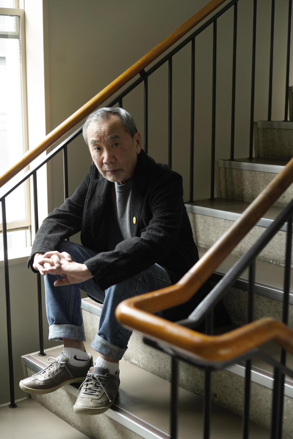 This photo released by Shinchosha, shows Haruki Murakami on March 17, 2023 at Shinchosha in Tokyo. Murakami wrote a story of a walled city when he was fresh off his debut. More than four decades later, as a seasoned and acclaimed novelist, he gave it a new life as “The City and Its Uncertain Walls.” (Kenji Sugano/Shinchosha via AP)