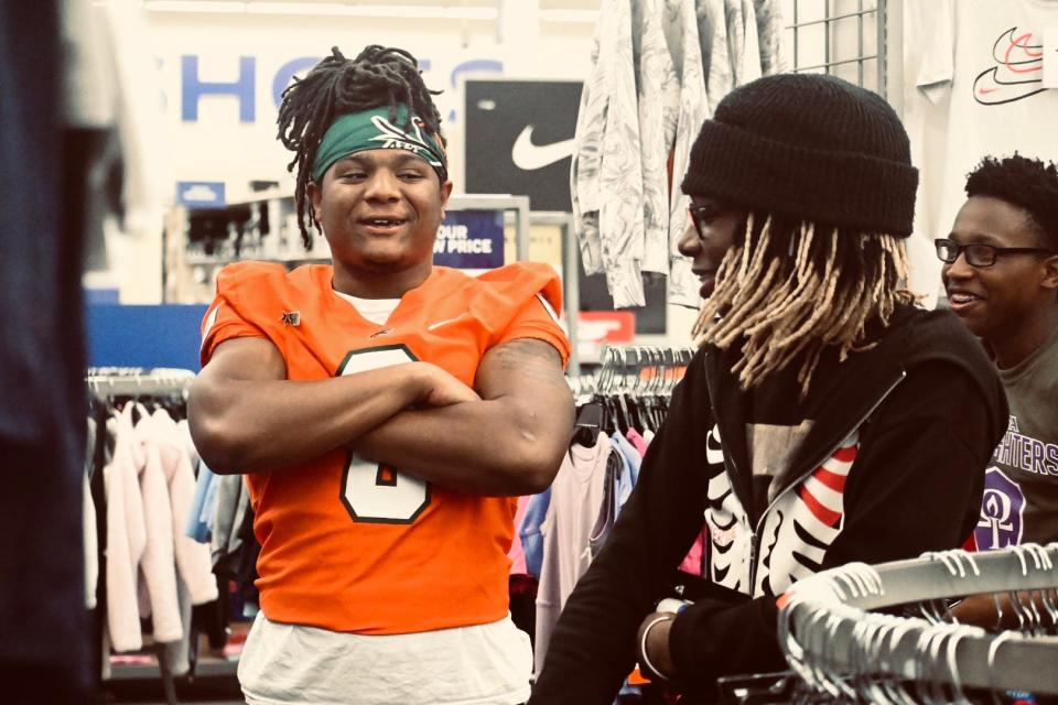 Isaiah Major helps a youth athlete shop at Academy Sports + Outdoors, May 18, 2022