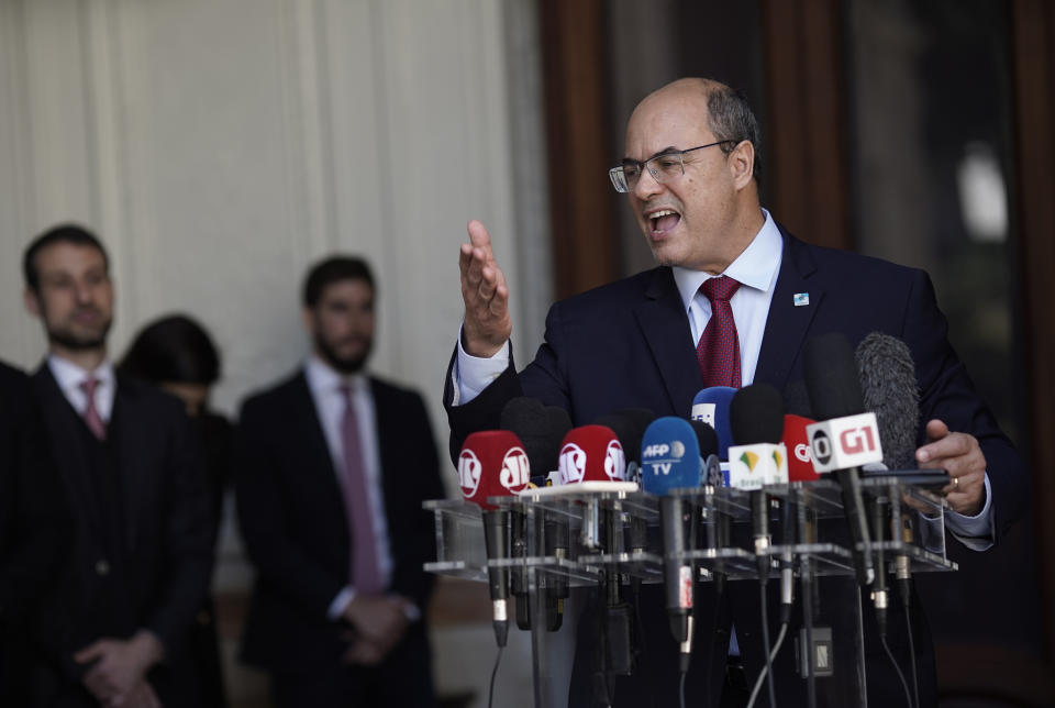 Wilson Witzel gives a statement after a court temporarily removed the former federal judge from his office of Rio de Janeiro state Governor due to corruption charges, at the Palacio de Laranjeiras governors residence in Rio de Janeiro, Brazil, Friday, Aug. 28, 2020. Investigators accuse Witzel of participating in a scheme involving fraud in public contracts to benefit companies linked to him and others under investigation. (AP Photo/Silvia Izquierdo)