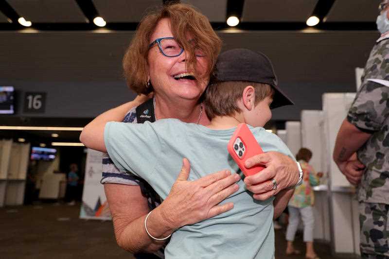 Passengers from Brisbane are greeted by family members after arriving at Perth domestic Airport in Perth.