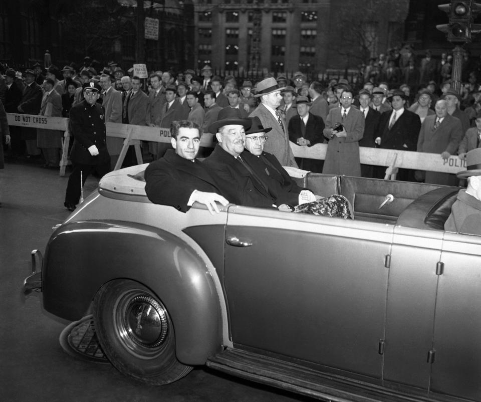 FILE - In this Nov. 21, 1949, file photo, Shah Mohammad Reza Pahlavi of Iran, left, Grover Whalen, representing the Mayor of New York, center, and Hussein Ala, Iranian Ambassador to the U.S., right, ride through Broadway on their way to an official reception for Pahlavi at City Hall, in New York. It wasn’t always the case of venturing into “enemy” territory for Iranian leaders when they visited the United Nations in New York. Shah Mohammad Reza Pahlavi was a key U.S. ally for decades. (AP Photo/File)