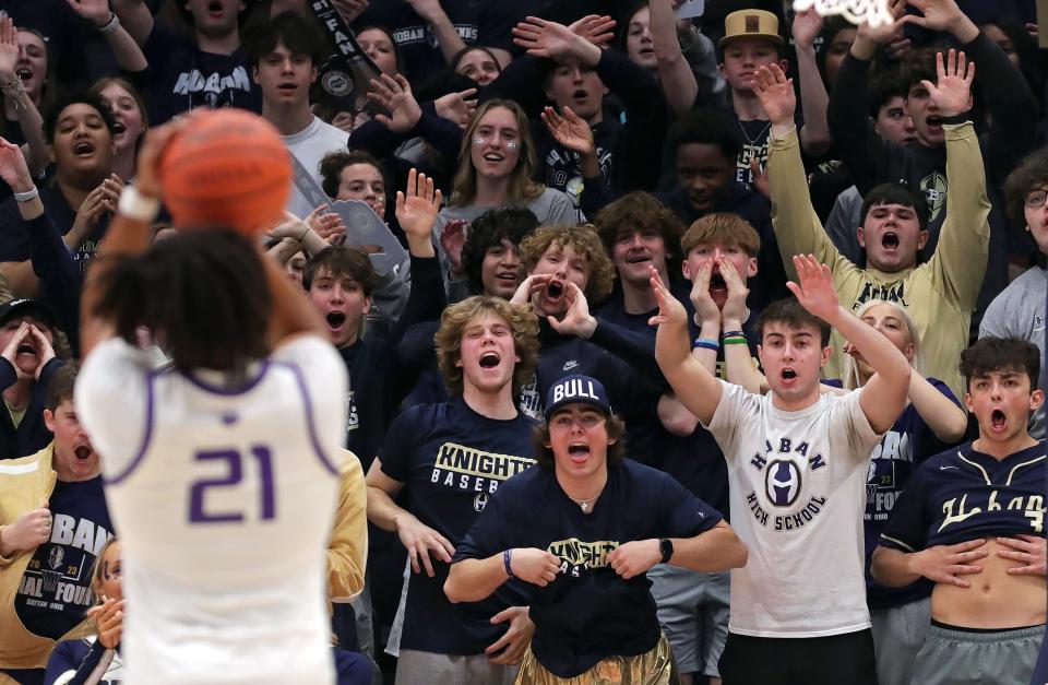 The Hoban student section heckles Pickerington Central forward Devin Royal as he shoots a foul shot during the 2023 state boys basketball tournament at UD Arena in Dayton.