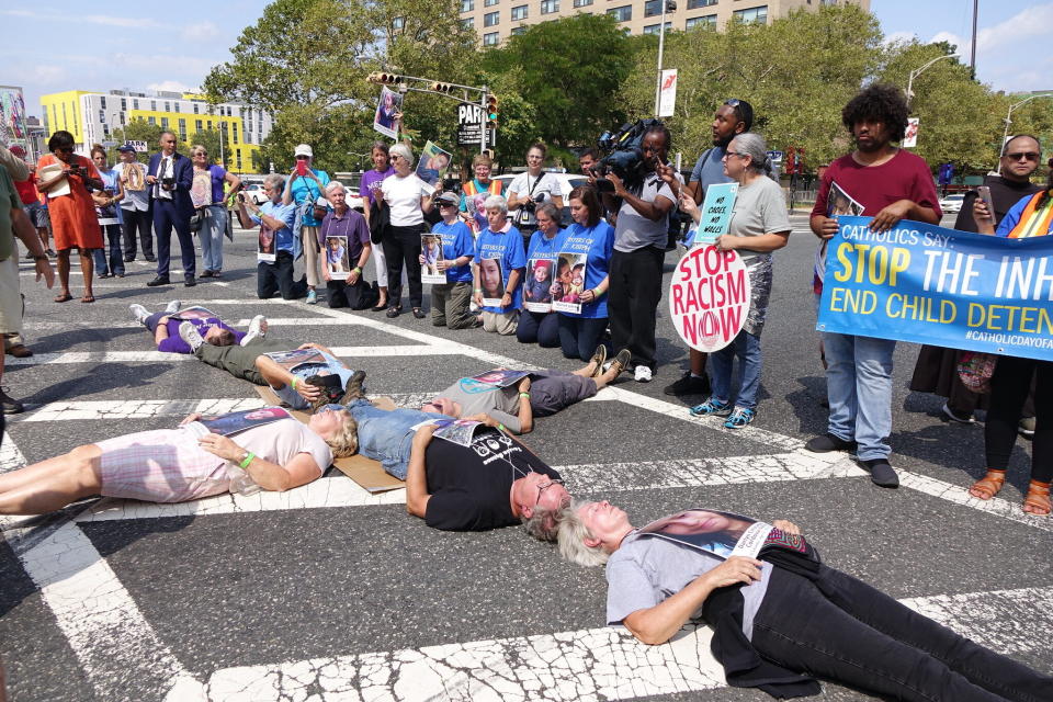 Catholic protesters form the shape of the cross and block a road outside Newark's Peter Rodino Federal Building, hoping to raise awareness of ICE's detention policies. (Photo: Ignatian Solidarity Network)