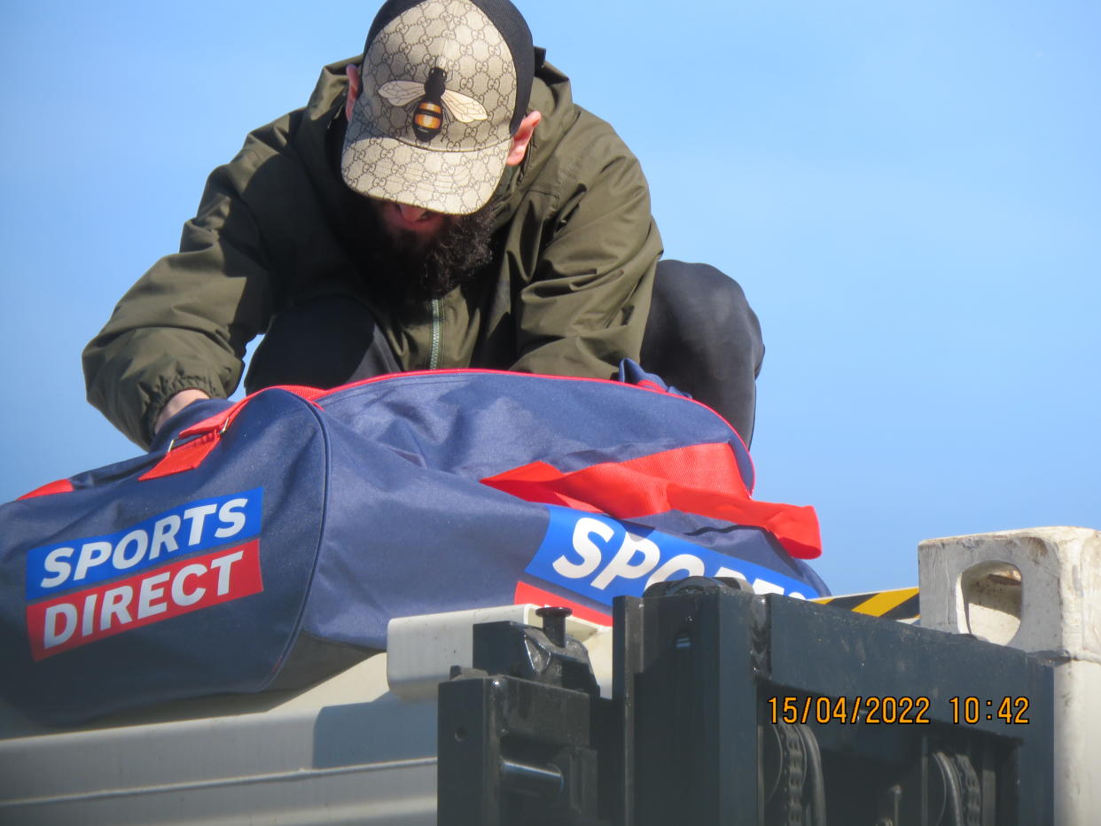 A surveillance shot of Ibra on top of the shipping container.