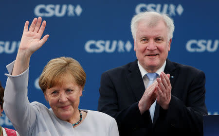 German Chancellor and head of the Christian Democratic Union (CDU) Angela Merkel and head of Christian Social Union (CSU) Horst Seehofer during the Trudering festival in Munich, Germany, May 28, 2017. REUTERS/Michaela Rehle