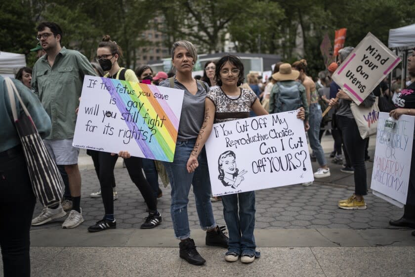 Amnet Ramos, 44, and her daughter, Inaia Hernandez, 12, stand for a portrait during a protest in Manhattan on Saturday, May 14, 2022, in New York where generations of women came together for a protest against the U.S. Supreme Court's anticipated ruling overturning Roe v. Wade. Ramos has protested since the Trump administration, and the threat to abortion rights has steeled her resolve to be heard - and that of her daughter. (AP Photo/Wong Maye-E)