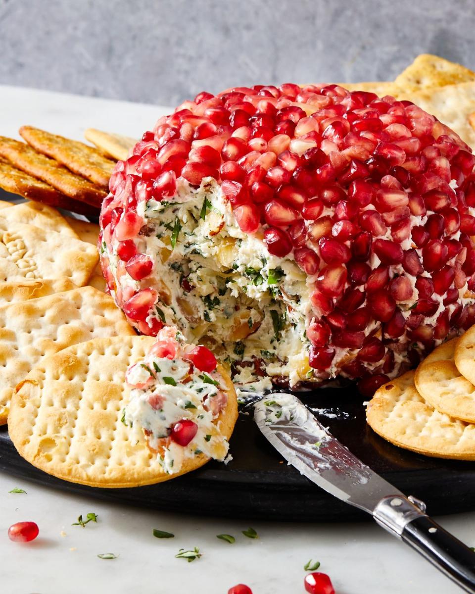 fancy christmas cheese ball covered in pomegranate seeds