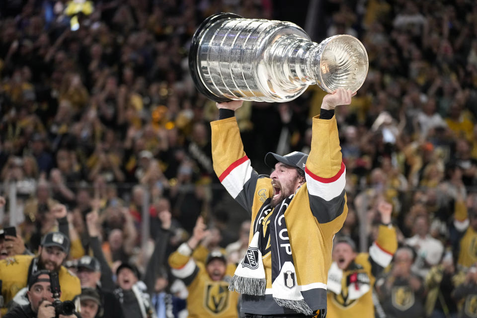 Vegas Golden Knights right wing Mark Stone hoists the Stanley Cup after the Knights defeated the Florida Panthers 9-3 in Game 5 of the NHL hockey Stanley Cup Finals Tuesday, June 13, 2023, in Las Vegas. The Knights won the series 4-1. (AP Photo/John Locher)