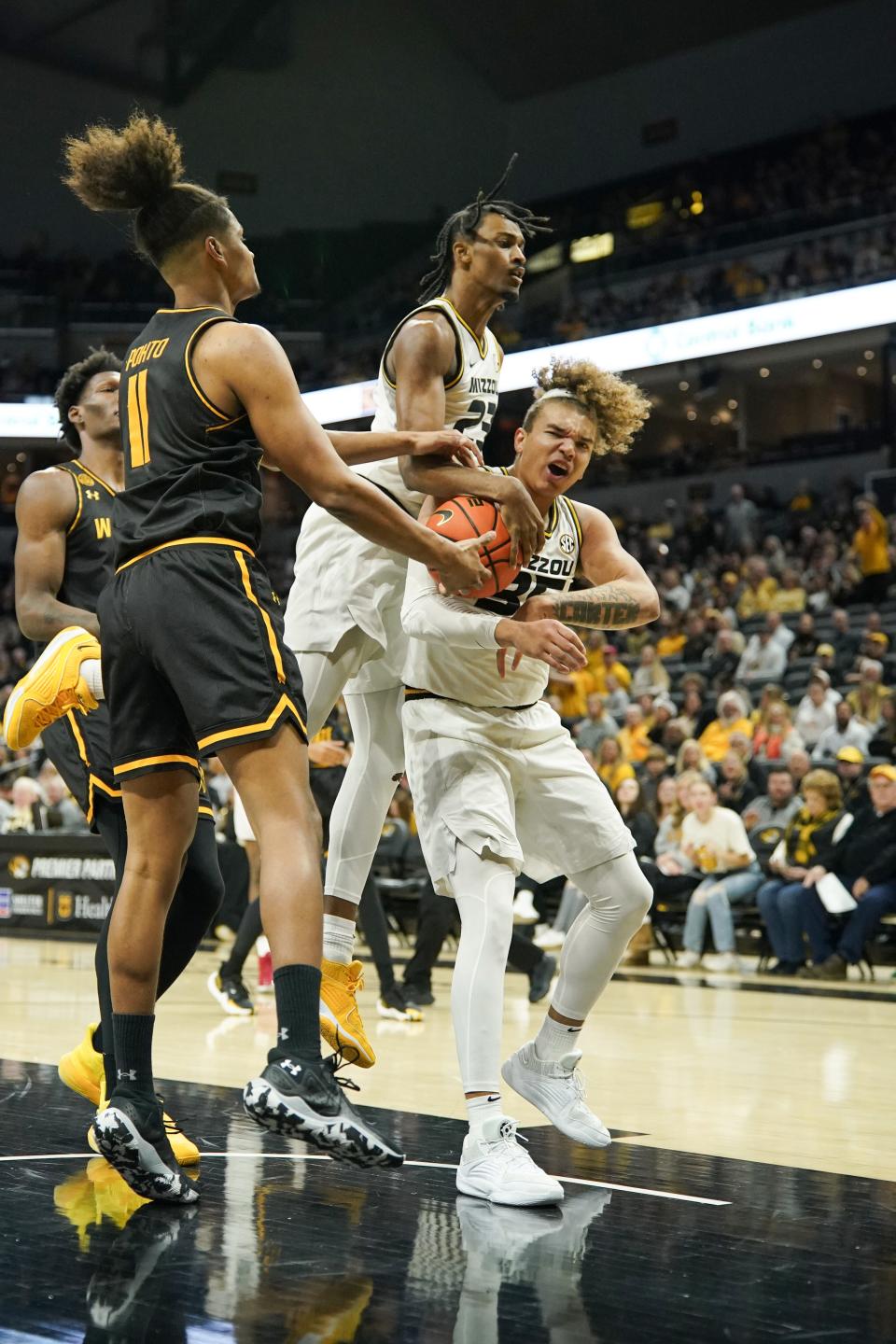 Dec 3, 2023; Columbia, Missouri, USA; Wichita State Shockers forward Kenny Pohto (11) and Missouri Tigers forward Noah Carter (35) fight for a rebound during the first half at Mizzou Arena. Mandatory Credit: Denny Medley-USA TODAY Sports
