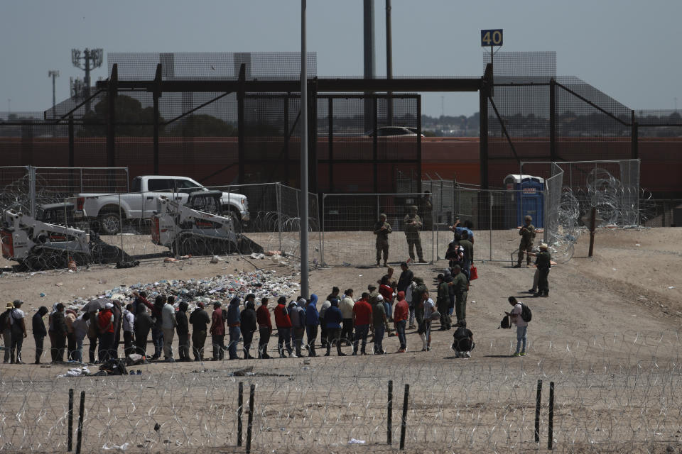 Migrants line up after being detained by US authorities at the US-Mexico border in Ciudad Juárez, Mexico, Sunday, April 30, 2023. (AP Photo/Christian Chávez)