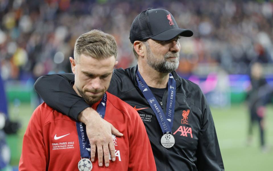 Liverpool's head coach Jurgen Klopp (R) and his player Jordan Henderson react after losing the UEFA Champions League final - SHUTTERSTOCK
