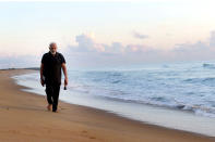 In this photo provided by Prime Minister of India Narendra Modi's twitter handle, Indian Prime Minister Narendra Modi takes morning walk at a beach in Mamallapuram, in southern India, Saturday, Oct. 12, 2019. India's foreign ministry said Chinese President Xi Jinping and Modi met in the seaside temple town of Mamallapuram over dinner for nearly two hours on Friday. The talks will continue Saturday. (Prime Minister of India Narendra Modi's twitter handle via AP Photo)