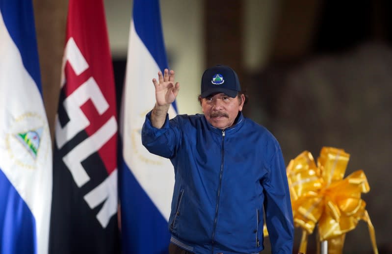 Nicaraguan President Daniel Ortega greets supporters during the opening ceremony of a highway overpass in Managua