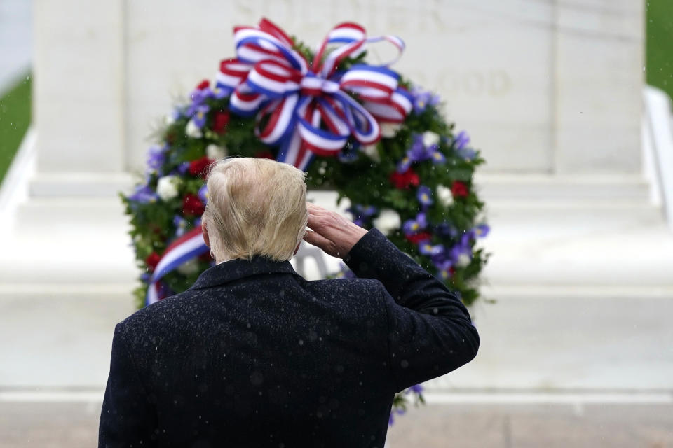 President Donald Trump salutes as he participates in a Veterans Day wreath laying ceremony at the Tomb of the Unknown Soldier at Arlington National Cemetery in Arlington, Va., Wednesday, Nov. 11, 2020. (AP Photo/Patrick Semansky)