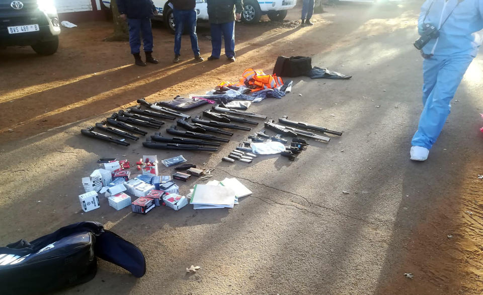 In this photo made available by the South African Police Services (SAPS), confiscated arms and ammunition, lay on the ground at a church in Zuurbekom, near Johannesburg, Saturday, July 11, 2020. Police in South Africa say five people are dead and more than 40 have been arrested after an early-morning hostage situation at a church near Johannesburg. (South African Police Services via AP)