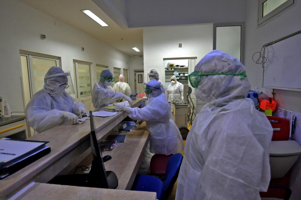 A members of the medical staff prepares to enter a coronavirus room at the intensive care unit of the Ariana Abderrahmen Mami hospital in the city of Ariana near the Tunisian capital Tunis on January 27, 2020, during the coronavirus pandemic crisis. (Photo by FETHI BELAID / AFP) (Photo by FETHI BELAID/AFP via Getty Images)