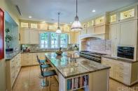 <p>The kitchen boasts a massive centre island. (Trulia) </p>