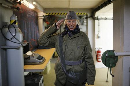 37 year-old Andrea Friebe, who works as fitness coach, dressed in a NVA soldier uniform, poses during her 'reality event' at the 'Bunker-Museum' in Rennsteighoehe near the eastern city of Ilmenau October 12, 2013. REUTERS/Ina Fassbender