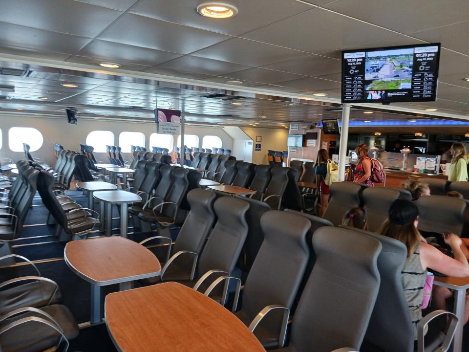 Lake Ferry interior with wood tables and chairs lined up between them
