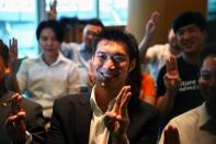 Thailand's opposition Future Forward Party leader Thanathorn Juangroongruangkit flashes three finger salute before hearing the verdict from the Constitutional Court at the party headquarters in Bangkok