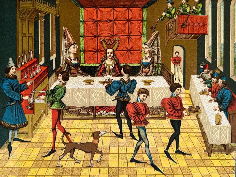 Illustration from 19th century of a Medieval banquet in a castle.