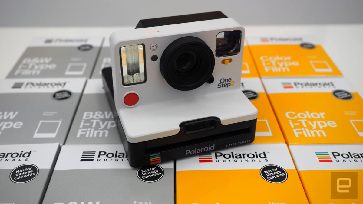 Polaroid Originals Onestep+ White and Black rainbow camera with i-type 600  film and Bluetooth is connected to the phone.