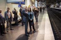 French Prime Minister Jean-Marc Ayrault (centre) at the Luxembourg station in Paris as he awaits a suburban train on Paris' Regional Express Network (RER) line B while campaigning for Sunday's parliamentary elections
