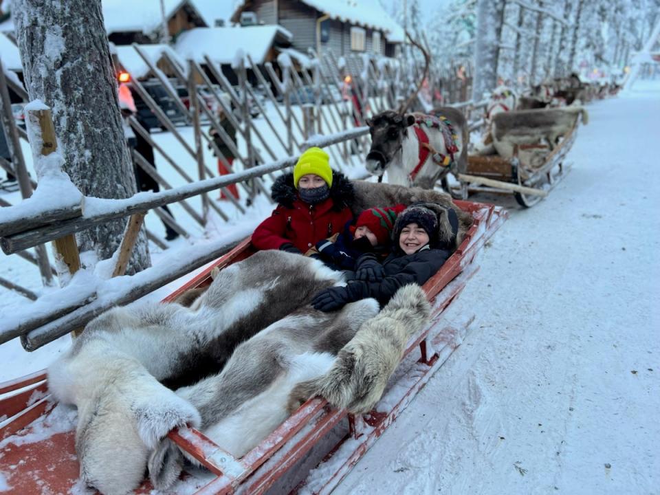 Maisie, Pippa and Marley in a toboggan in Lapland, December 2022. (Carl Jackson / SWNS)