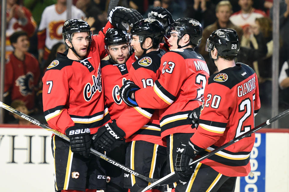 Dec 6, 2014; Calgary, Alberta, CAN; Calgary Flames defenseman Mark Giordano (5) (second from left) celebrates his first period goal against the San Jose Sharks at Scotiabank Saddledome. (Candice Ward-USA TODAY Sports)