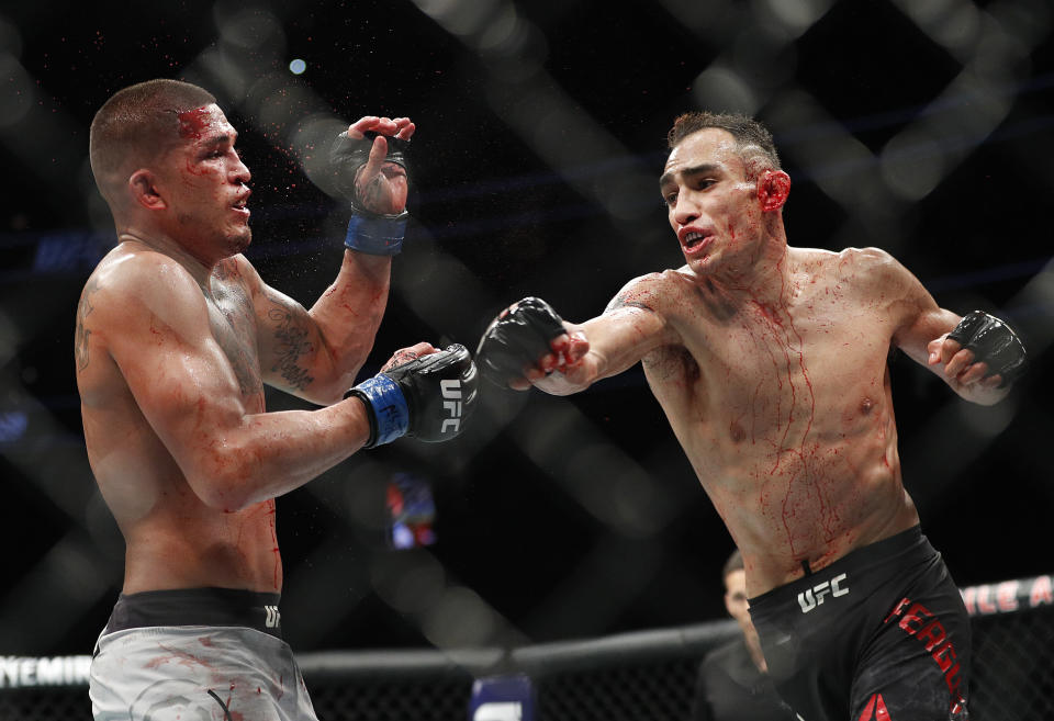 Tony Ferguson, right, punches Anthony Pettis during a lightweight mixed martial arts bout mixed martial arts bout at UFC 229 in Las Vegas, Saturday, Oct. 6, 2018. Ferguson won by technical knockout during the second round. (AP Photo/John Locher)