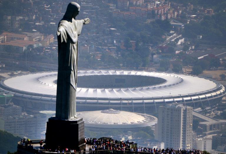 Aerial view of the Christ the Redeemer statue atop Corcovado Hill and the Mario Filho (Maracana) stadium, in Rio de Janeiro, Brazil, seen on May 10, 2013