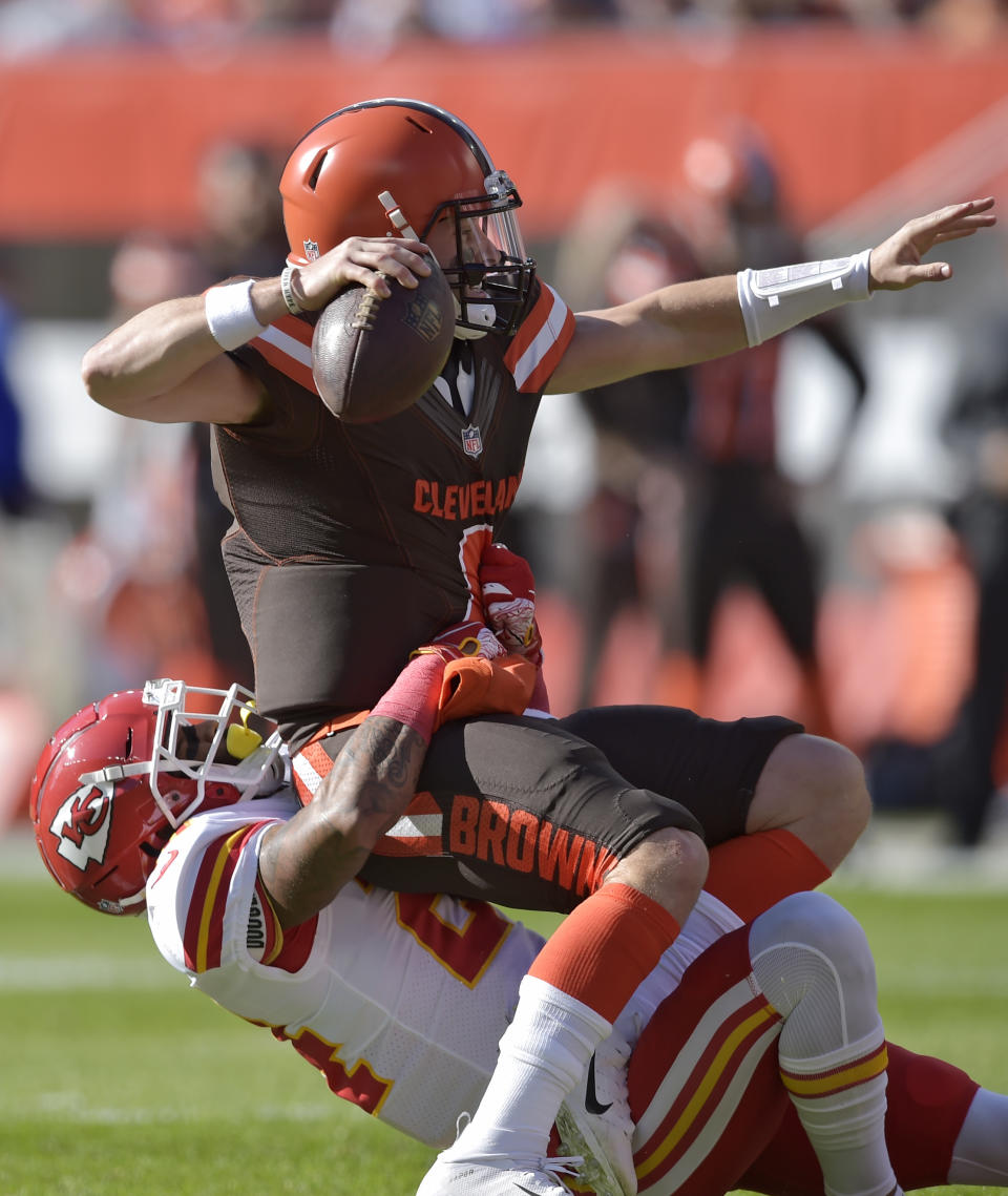<p>Cleveland Browns quarterback Baker Mayfield, top, is sacked by Kansas City Chiefs strong safety Jordan Lucas during the first half of an NFL football game, Sunday, Nov. 4, 2018, in Cleveland. (AP Photo/David Richard) </p>