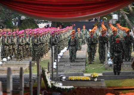 Indonesian soldiers take part in a funeral ceremony of former Indonesian President B.J. Habibie, who passed away yesterday, at Kalibata Heroes Cemetery complex in Jakarta