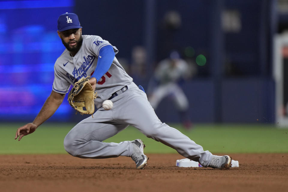 Los Angeles Dodgers second baseman Amed Rosario catches a wide throw unable to tag out Miami Marlins' Jazz Chisholm Jr. as he stole second base during the fourth inning of a baseball game, Tuesday, Sept. 5, 2023, in Miami. (AP Photo/Wilfredo Lee)