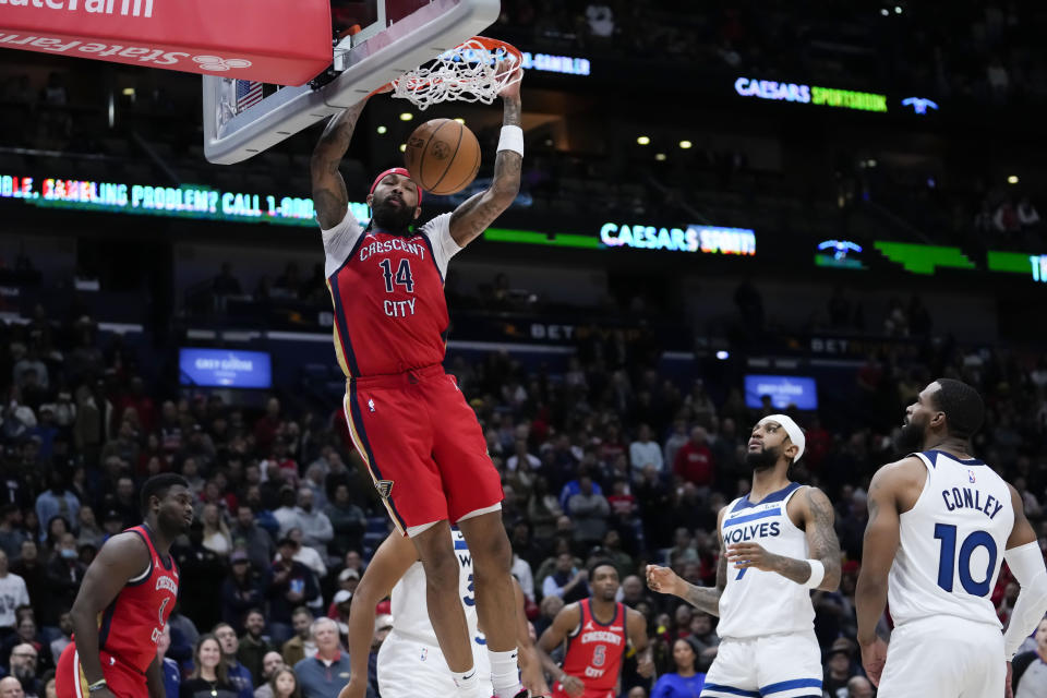 New Orleans Pelicans forward Brandon Ingram (14) slam dunks in the first half of an NBA basketball game against the Minnesota Timberwolves in New Orleans, Monday, Dec. 11, 2023. (AP Photo/Gerald Herbert)