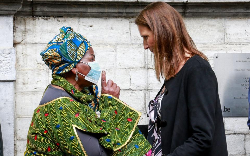 Belgium's Prime Minister Sophie Wilmes (R) speaks with a resident as she unveils a plaque during the celebrations marking the 60th anniversary of the DR Congo's independence from Belgium - Shutterstock